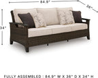Signature Design by Ashley Drakes Beach 3-Seat Outdoor Sofa, Brown Wicker | Sturdy aluminum frame, Woven-look dark brown resin wicker, Bleach cleanable Nuvella fabric, 4 throw pillows included