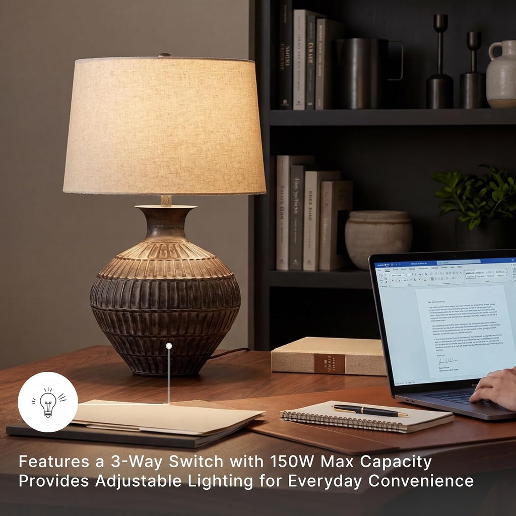 Signature Design by Ashley Magan Metal Table Lamp, 28", Antique Bronze | Antique bronze-tone metal base, Textured pattern, Fabric modified drum shade, Living room or entryway use, 3-way switch