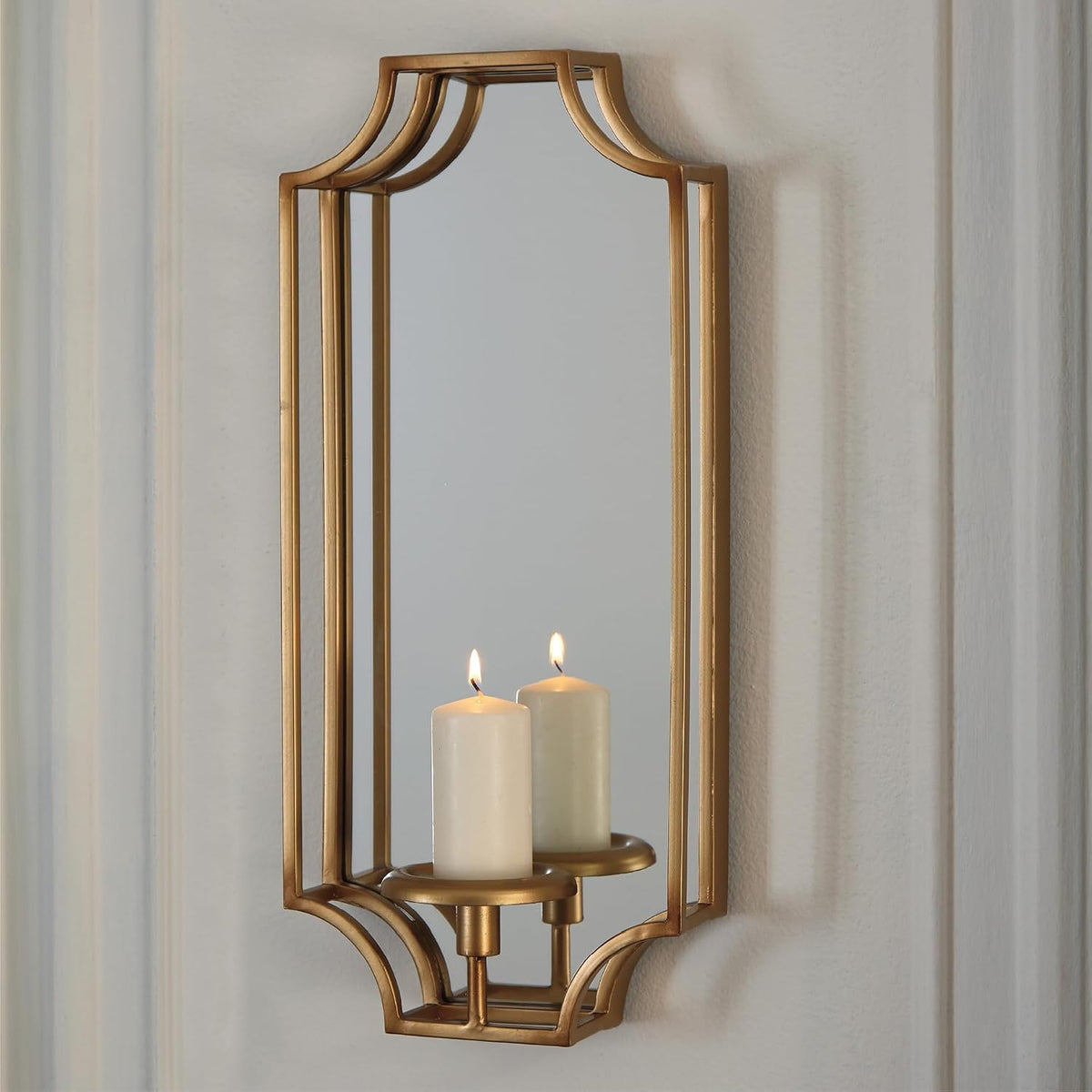 Signature Design by Ashley Pagoda Mirrored Metal Candle Wall Sconce, Gold | Polished 20-inch gold metal frame, Holds pillar or taper candles, Mirrored backplate to double ambient glow, Dumi Series