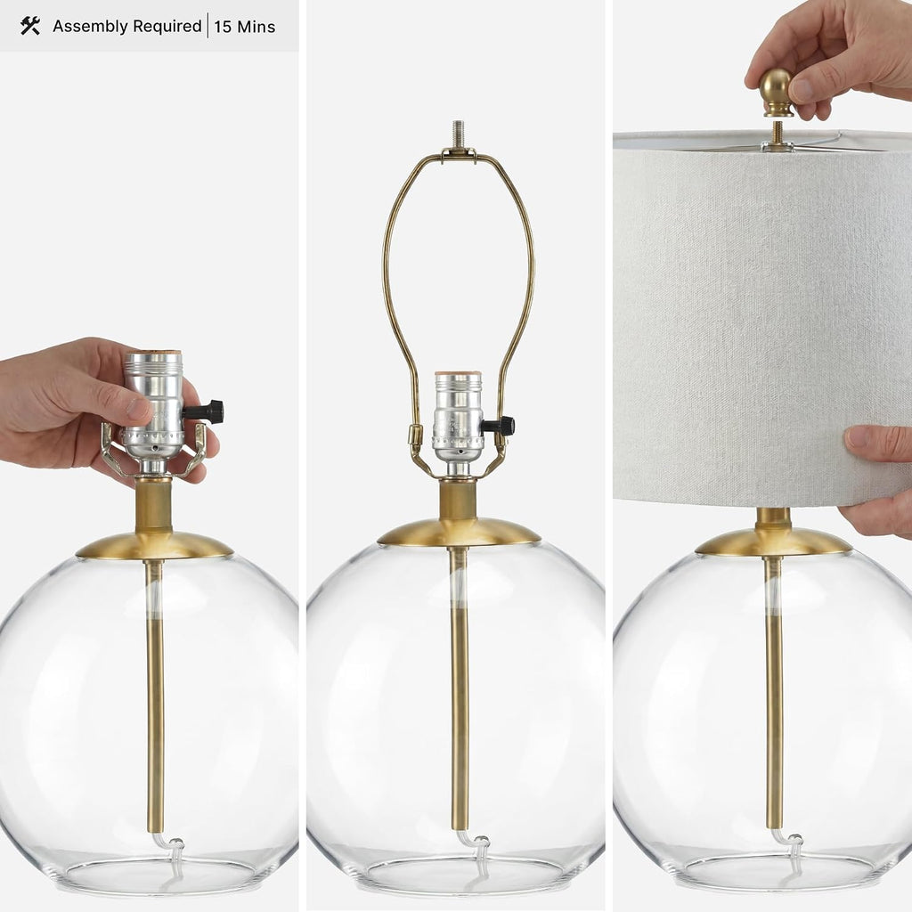 Signature Design by Ashley Glass Table Lamp, Modern Bedside, Clear & Brass | White fabric drum shade, Compact round clear glass profile for modern nightstands, Samder Series