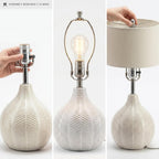 Signature Design by Ashley Rainermen Ceramic Table Lamp, 21", Off White | Textured herringbone base, Transparent white glaze, Hardback fabric drum shade, Bedside use, 92.5-inch cord, E26 socket