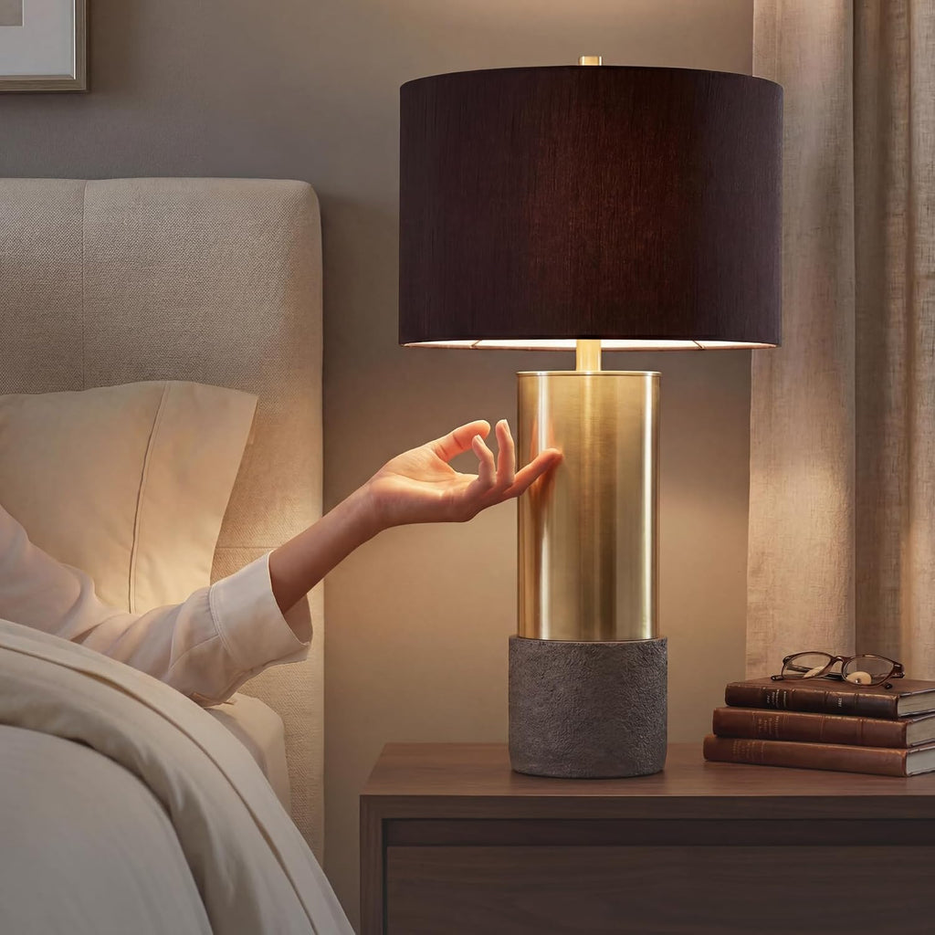 Signature Design by Ashley Jacek Contemporary Table Lamp Set of 2 | Textured faux concrete and brass-finished metal, Black drum shade with goldtone foil interior, Living room and bedside use
