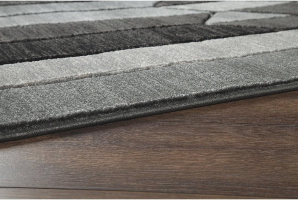 Signature Design by Ashley Chayse Geometric Area Rug, 7x10, Black & Gray | 100% polypropylene fiber, 12 mm medium pile height, Hand-carved multidimensional design, Large living room use, Spot clean