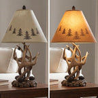Signature Design by Ashley Derek Rustic Table Lamps, Living Room, Set of 2 | Durable poly resin antler base, Warm translucent paper silhouette shade projecting forest scenes, Rustic cabin style