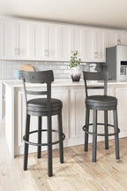 Signature Design by Ashley 30" Swivel Bar Height Bar Stool, Antiqued Black | Solid wood and metal frame, Easy-clean black faux leather seat with 360 swivel, Valebeck Series