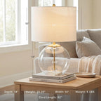 Signature Design by Ashley Glass Table Lamp, Modern Bedside, Clear & Brass | White fabric drum shade, Compact round clear glass profile for modern nightstands, Samder Series