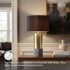 Signature Design by Ashley Jacek Contemporary Table Lamp Set of 2 | Textured faux concrete and brass-finished metal, Black drum shade with goldtone foil interior, Living room and bedside use