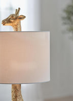 Signature Design by Ashley Giraffe Table Lamp, Goldtone Safari Animal Lamp | Sturdy goldtone polyresin base, Cotton and polyester drum hardback fabric shade, 25-inch tall modern safari style, Ferrison
