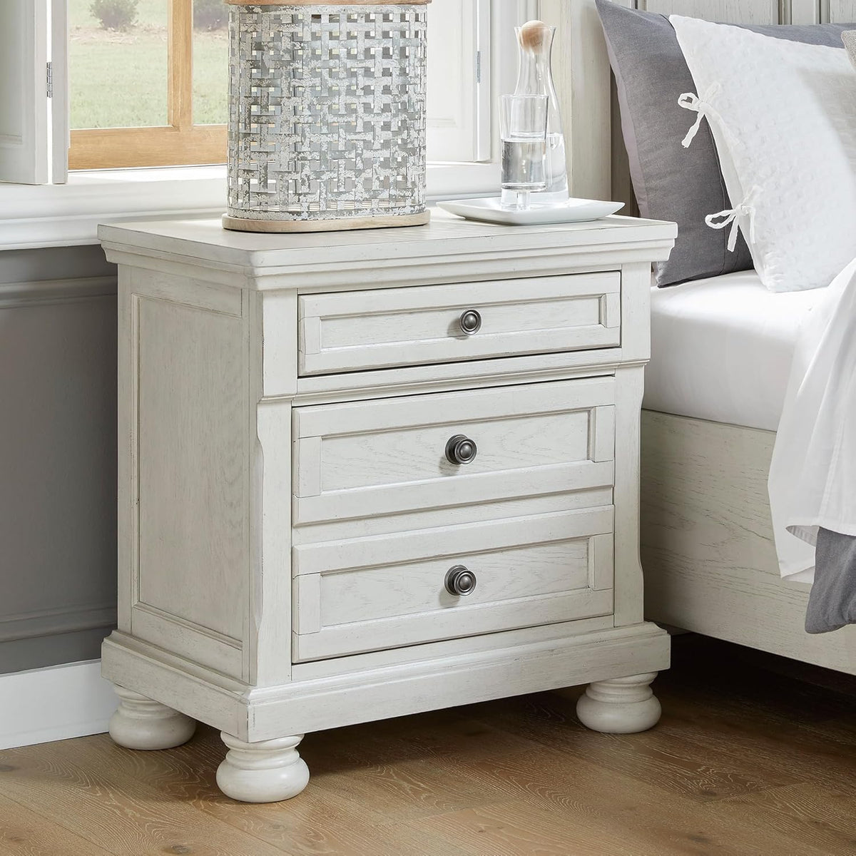 Signature Design by Ashley Tall Antique White Nightstand Wood Bedside Table | Two dovetail drawers, Hidden pull-out tray for valuables, Textured antiqued white oak finish, Robbinsdale Series