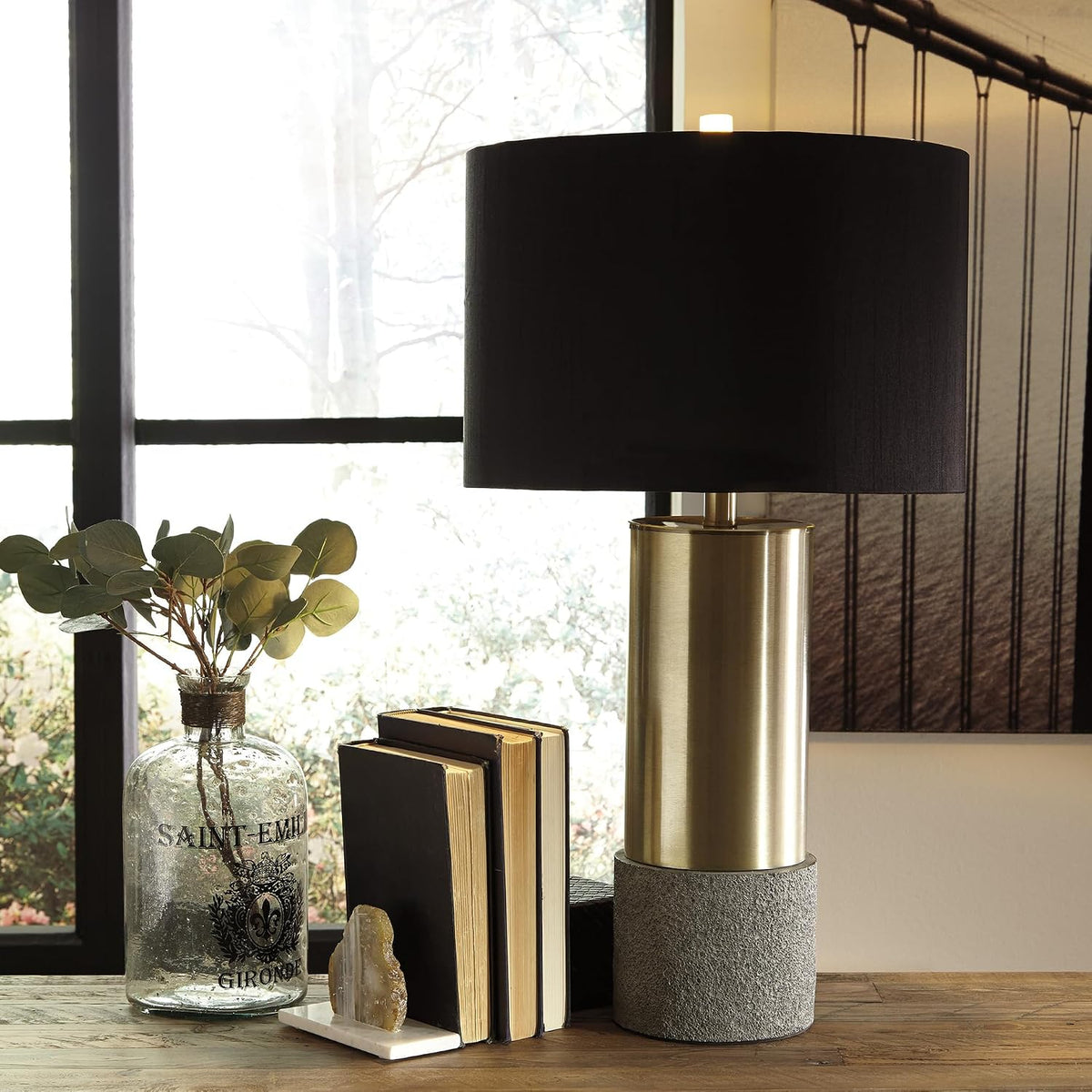 Signature Design by Ashley Jacek Contemporary Table Lamp Set of 2 | Textured faux concrete and brass-finished metal, Black drum shade with goldtone foil interior, Living room and bedside use