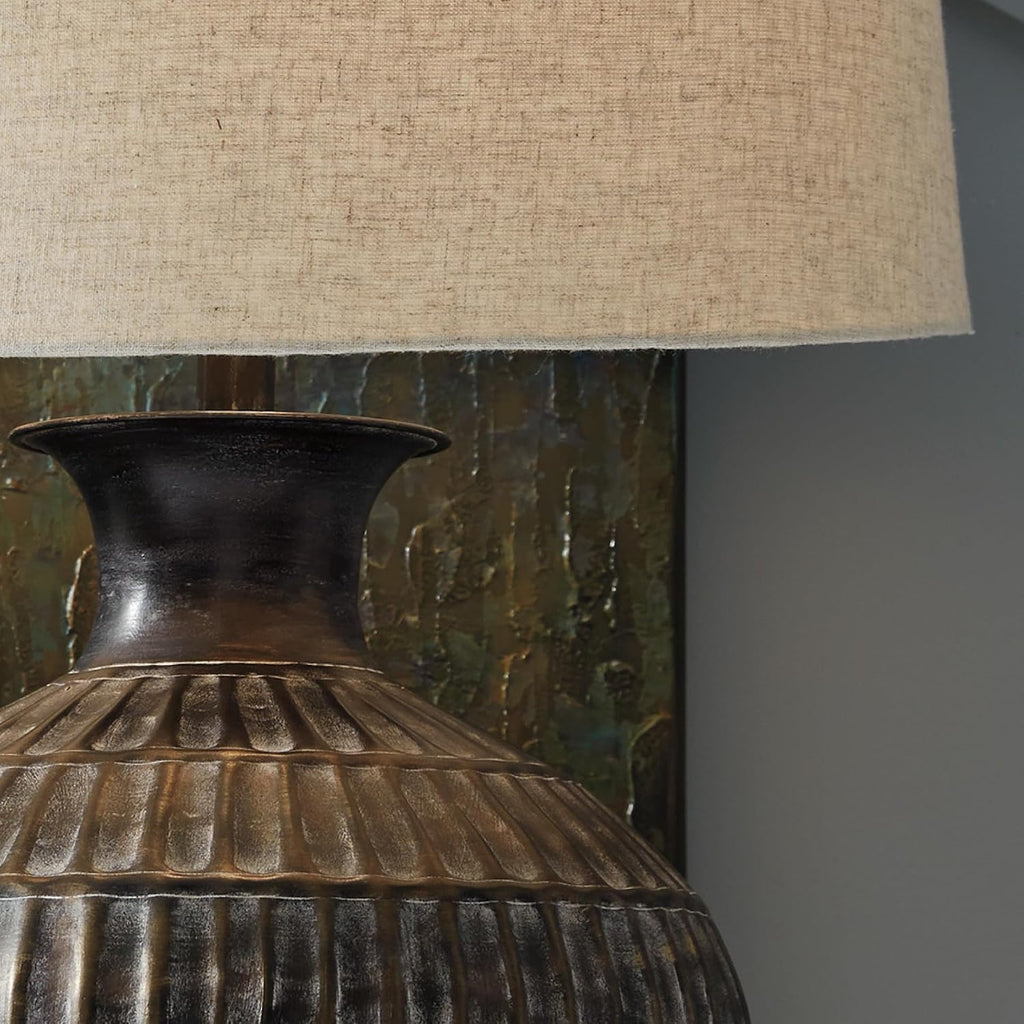 Signature Design by Ashley Magan Metal Table Lamp, 28", Antique Bronze | Antique bronze-tone metal base, Textured pattern, Fabric modified drum shade, Living room or entryway use, 3-way switch