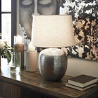 Signature Design by Ashley Magalie Metal Table Lamp, Antiqued Silver | Textured hammered aluminum base, Vintage warmth, Crisp modified drum shade, Cozy living room lighting