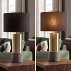 Signature Design by Ashley Jacek Contemporary Table Lamp Set of 2 | Textured faux concrete and brass-finished metal, Black drum shade with goldtone foil interior, Living room and bedside use