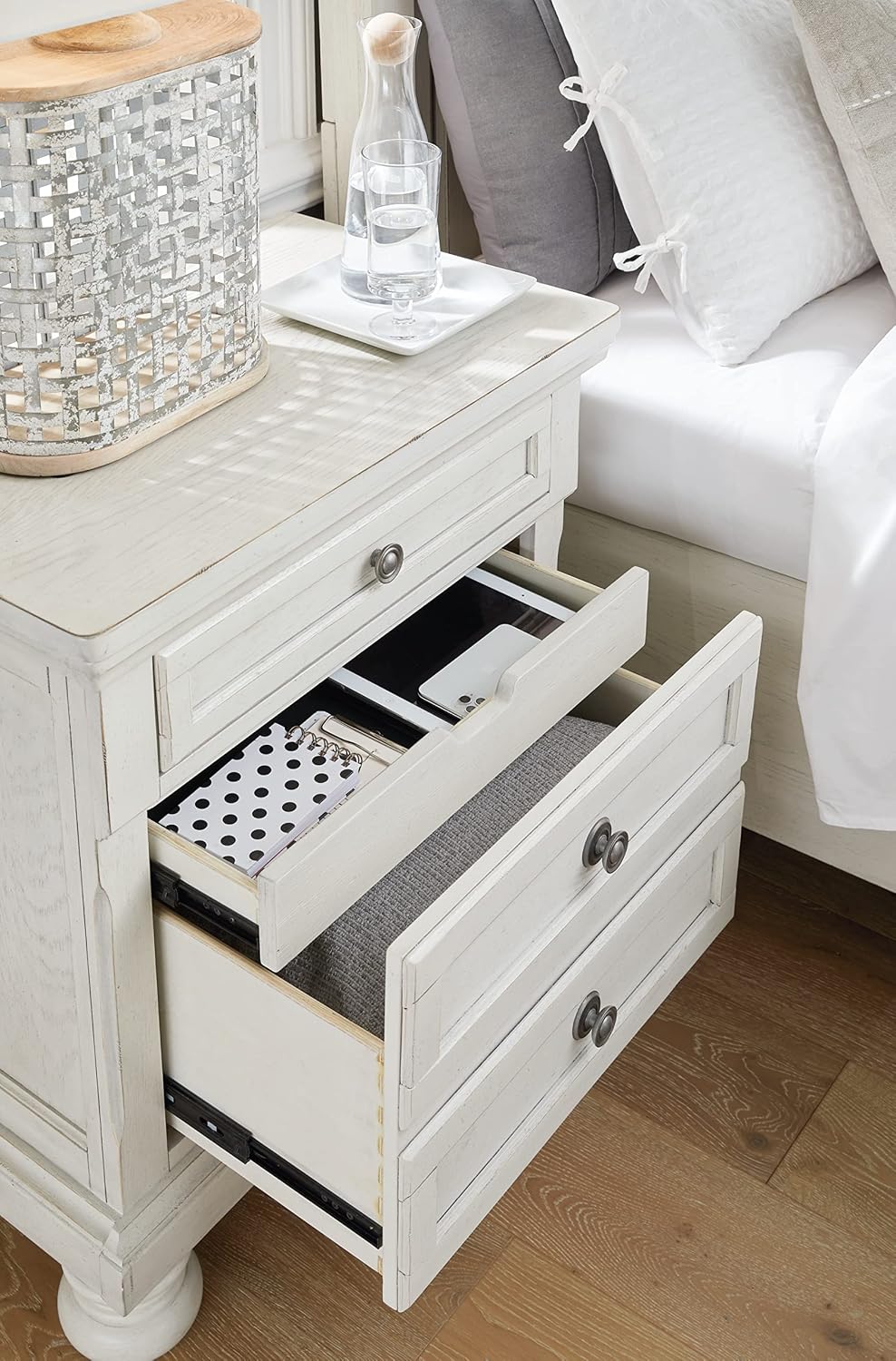 Signature Design by Ashley Tall Antique White Nightstand Wood Bedside Table | Two dovetail drawers, Hidden pull-out tray for valuables, Textured antiqued white oak finish, Robbinsdale Series