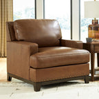 Signature Design by Ashley Oversized Brown Leather Accent Chair, Amber | Genuine and faux leather with brass-tone nailhead trim, Faux wood base, No assembly living room chairs, Brendola Series