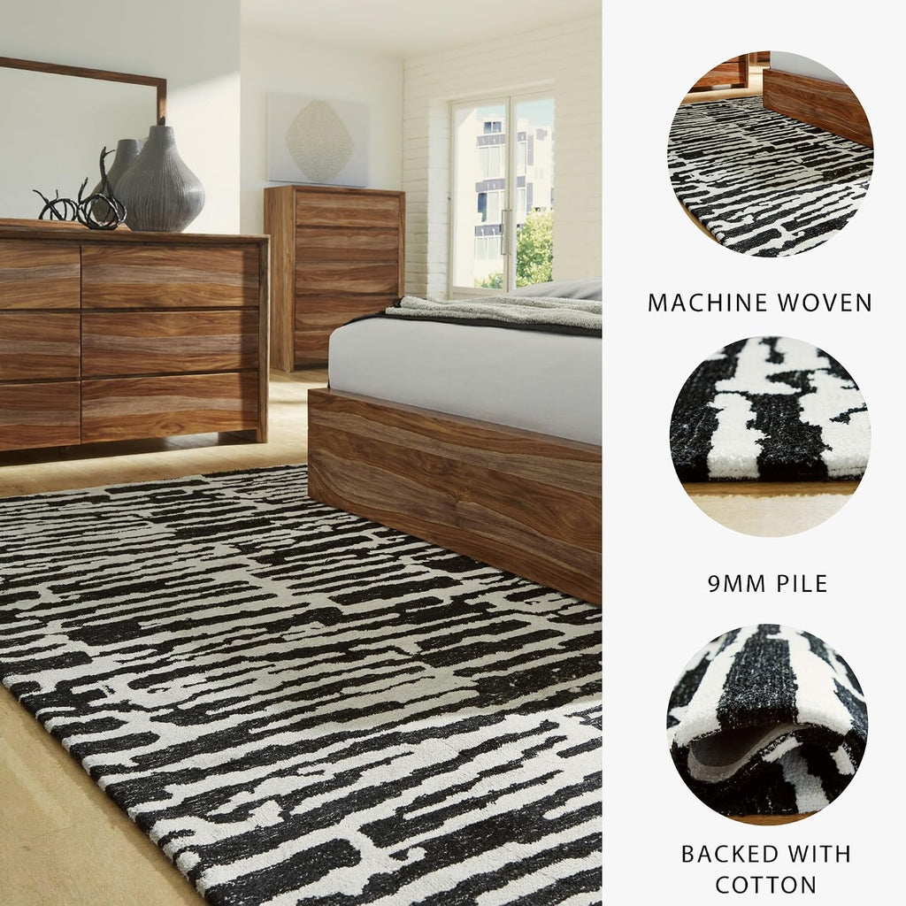 Signature Design by Ashley Bramshaw Area Rug, 8x10, Black and Ivory | Plush 9 mm medium-pile polyester, Protective woven cotton backing, Contemporary high-contrast pattern