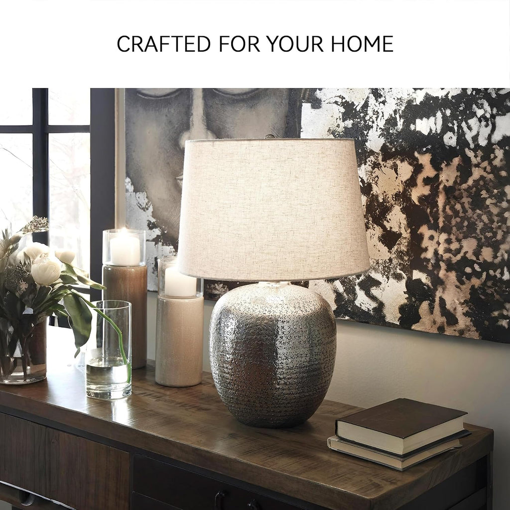 Signature Design by Ashley Magalie Metal Table Lamp, Antiqued Silver | Textured hammered aluminum base, Vintage warmth, Crisp modified drum shade, Cozy living room lighting