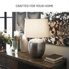 Signature Design by Ashley Magalie Metal Table Lamp, Antiqued Silver | Textured hammered aluminum base, Vintage warmth, Crisp modified drum shade, Cozy living room lighting