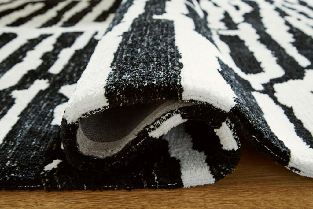 Signature Design by Ashley Bramshaw Area Rug, 8x10, Black and Ivory | Plush 9 mm medium-pile polyester, Protective woven cotton backing, Contemporary high-contrast pattern