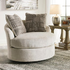 Signature Design by Ashley Soletren Oversized Swivel Accent Chair, Stone | Cozy 100% polyester chenille, Smooth 360-degree swivel base, Includes 2 geometric throw pillows