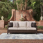 Signature Design by Ashley Drakes Beach 3-Seat Outdoor Sofa, Brown Wicker | Sturdy aluminum frame, Woven-look dark brown resin wicker, Bleach cleanable Nuvella fabric, 4 throw pillows included